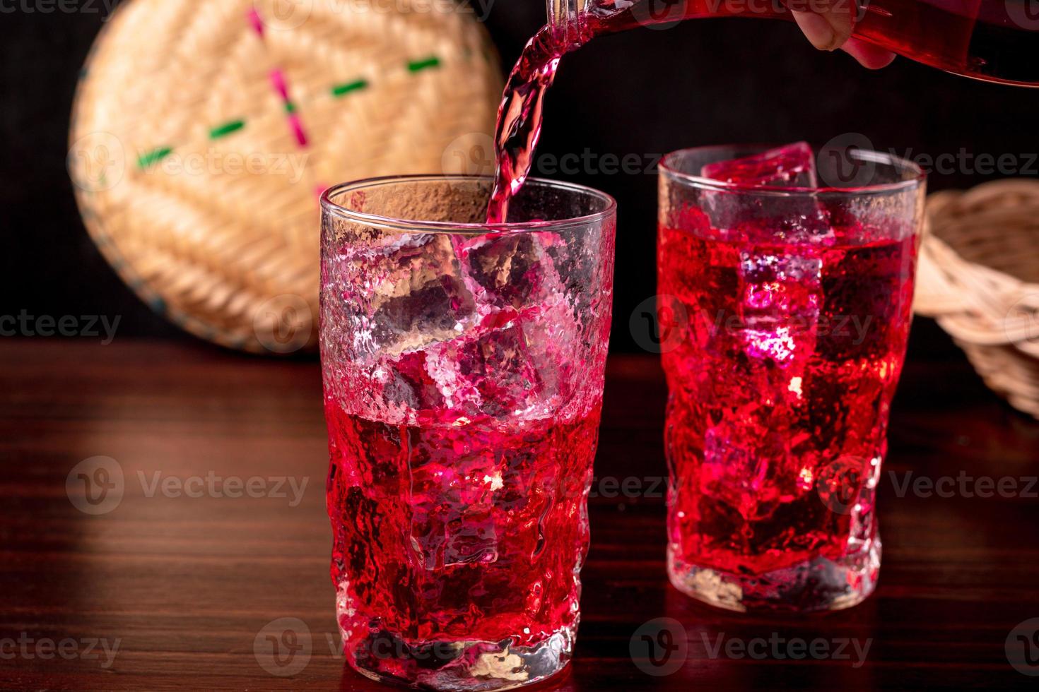 Red flavored nectar drink on a wooden background photo