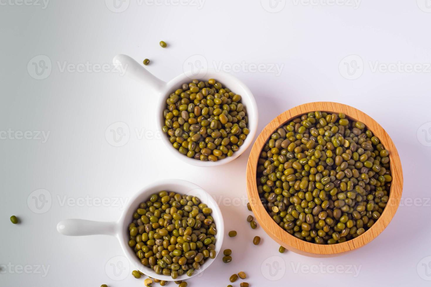 Green beans in a wooden cup on a white background photo