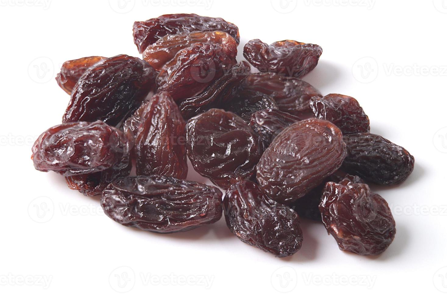 Black dried raisins on a white background photo
