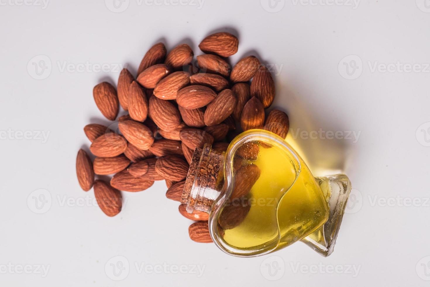 Almond oil on a wooden background photo