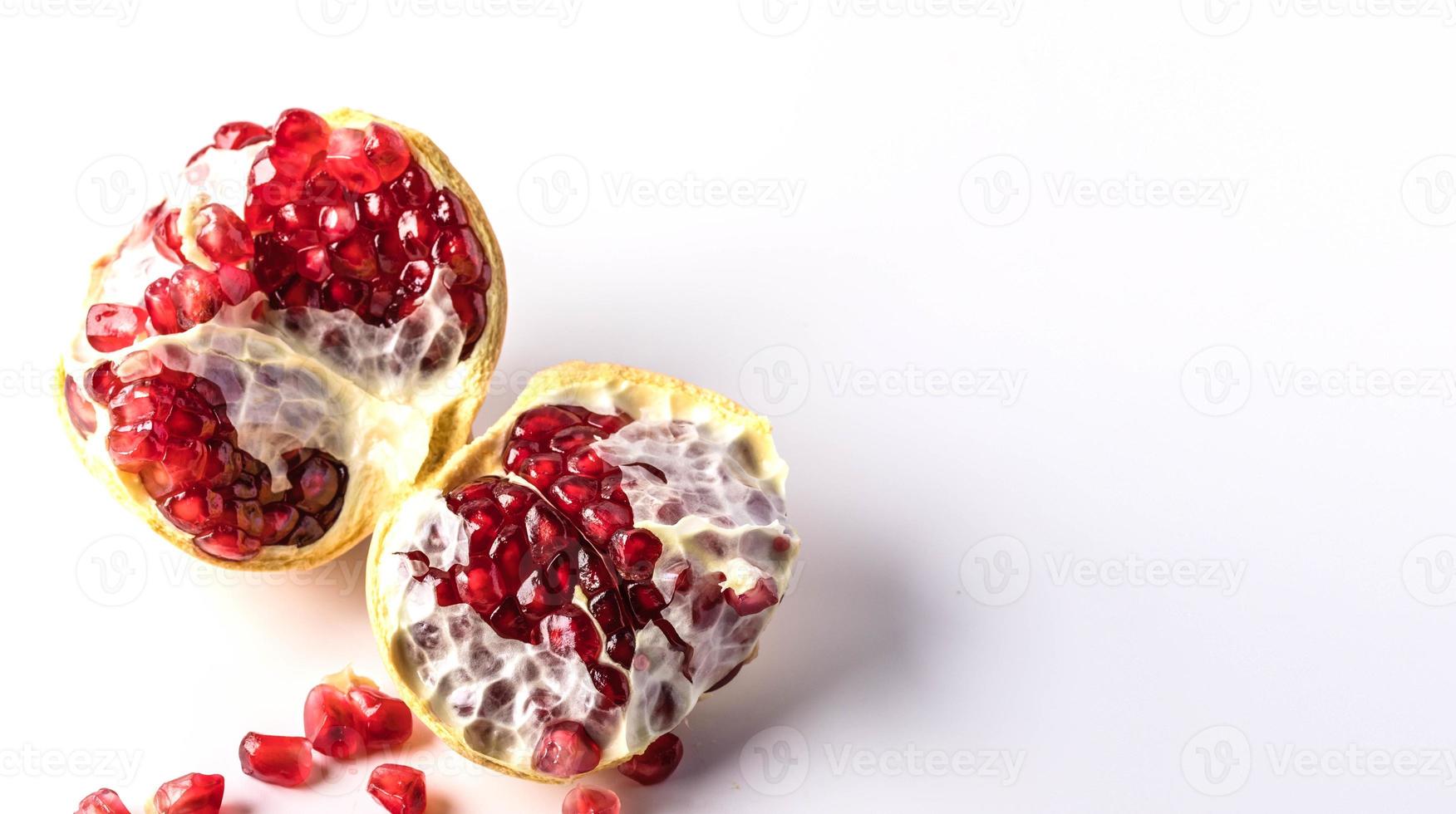 Dark red fruit pomegranate on white background copy space photo