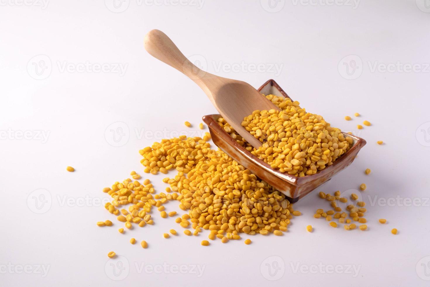 Hulled split mung bean in brown cup on white background photo
