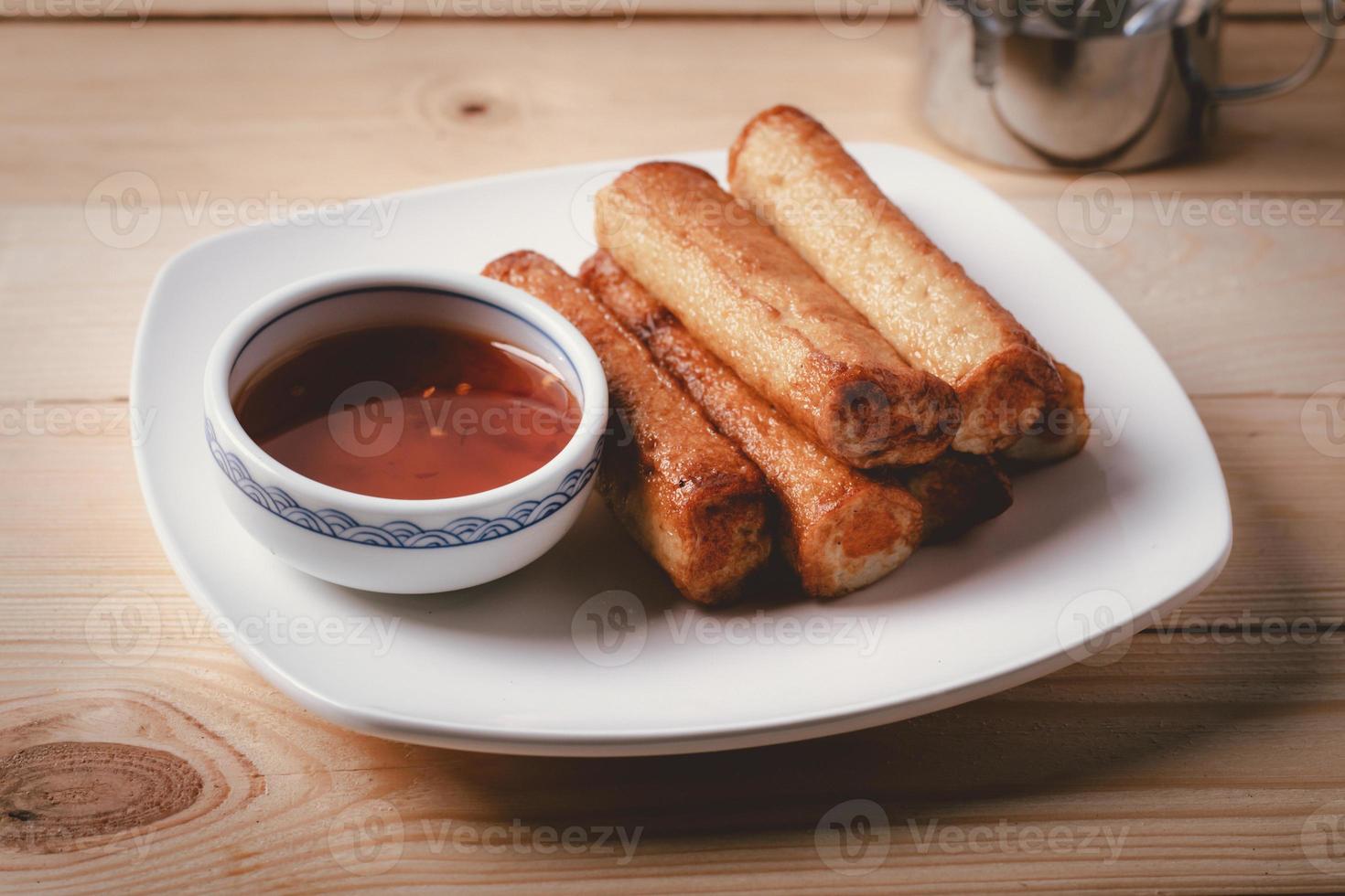 Fish ball fried with dipping sauce on a blue napkin photo