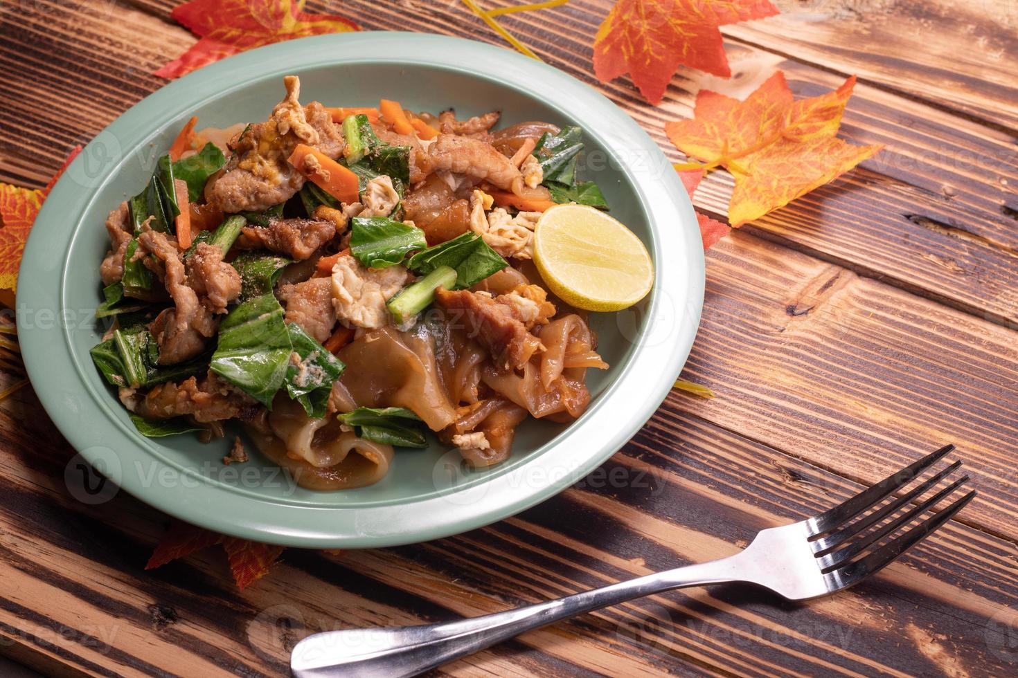 Fried noodles with pork and vegetables. Popular Thai food photo