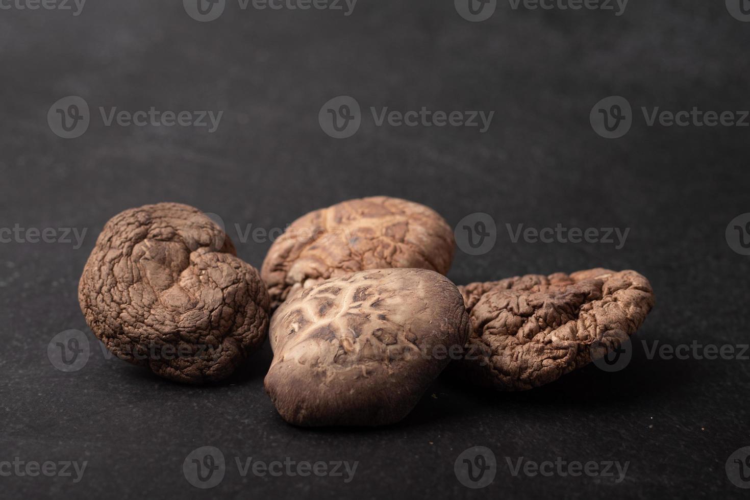 Dried shiitake mushrooms on a black background photo