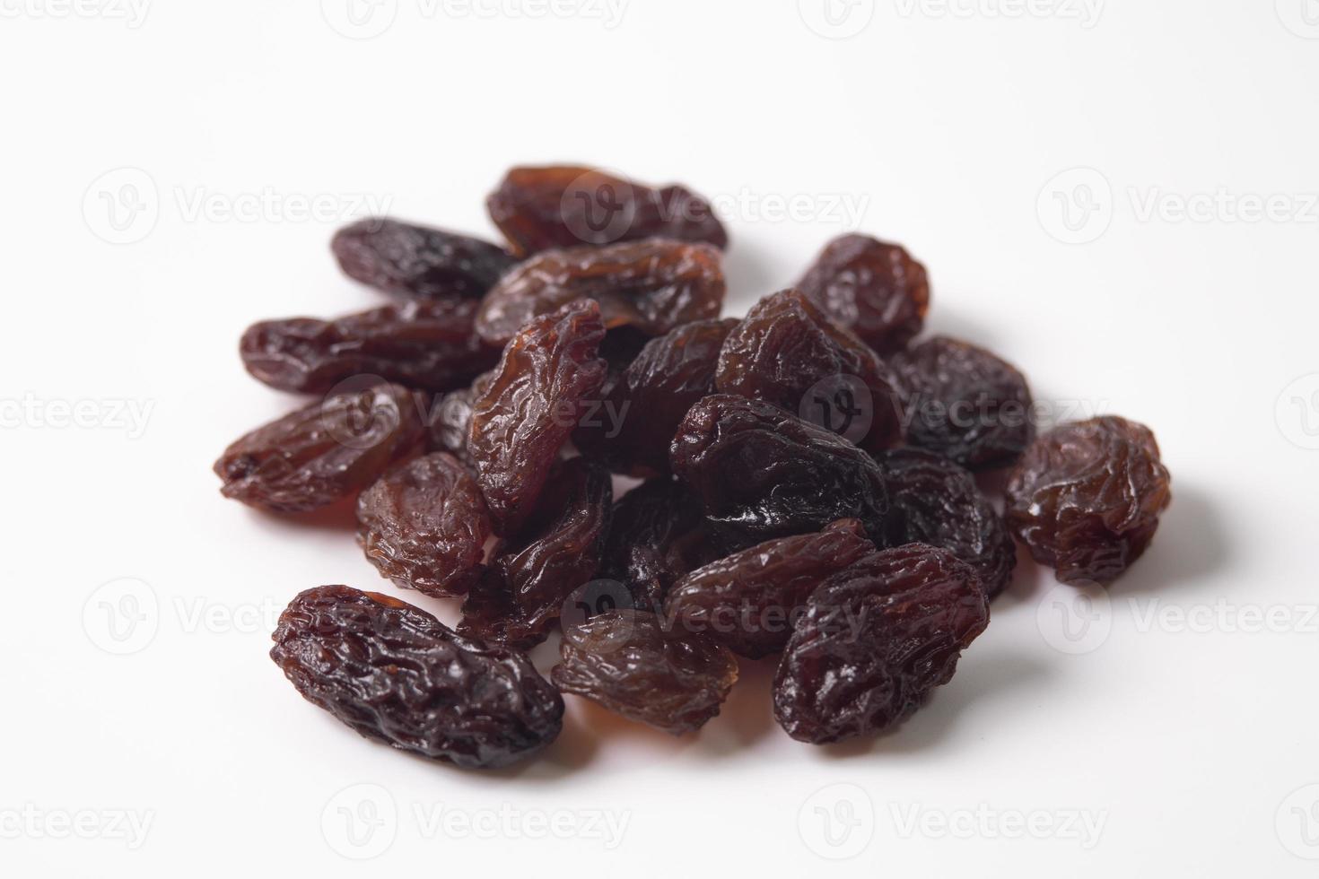 Black dried raisins on a white background photo