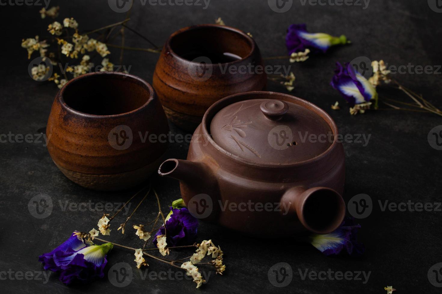 Antique brown chinese tea set on black background photo