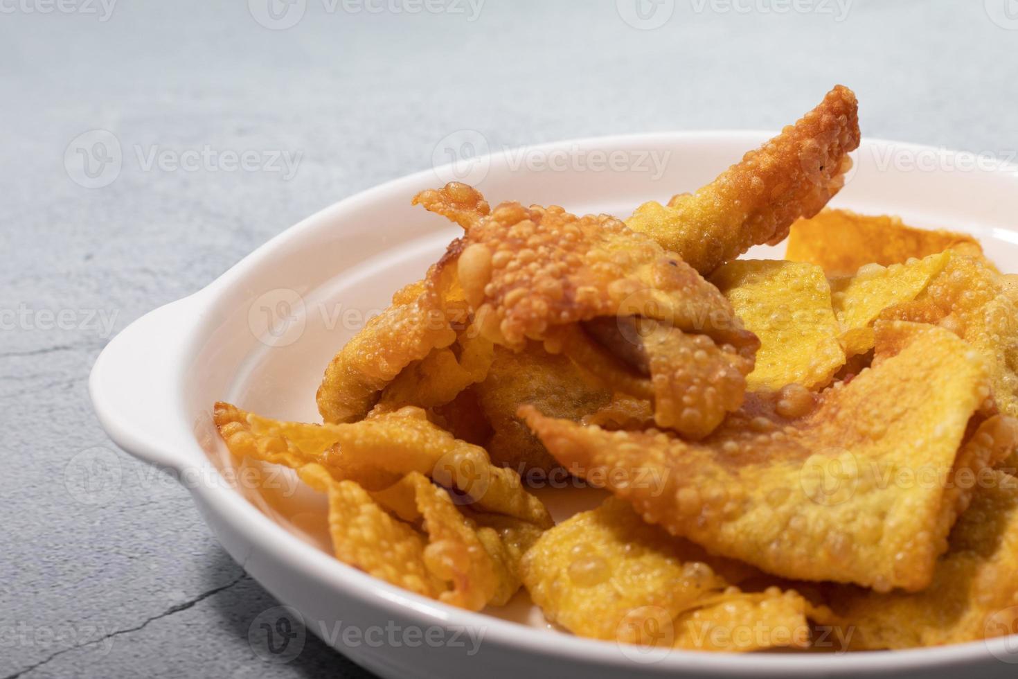 Yellow crispy dumplings on a white plate photo