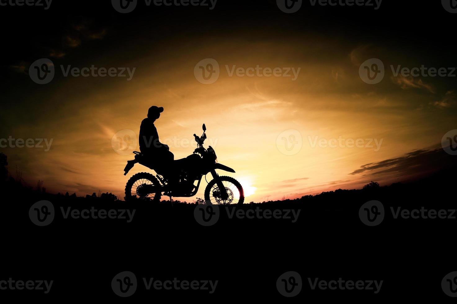 Men's silhouettes and touring motocross bikes. Park to relax in the mountains in the evening. adventure travel and leisure concept photo