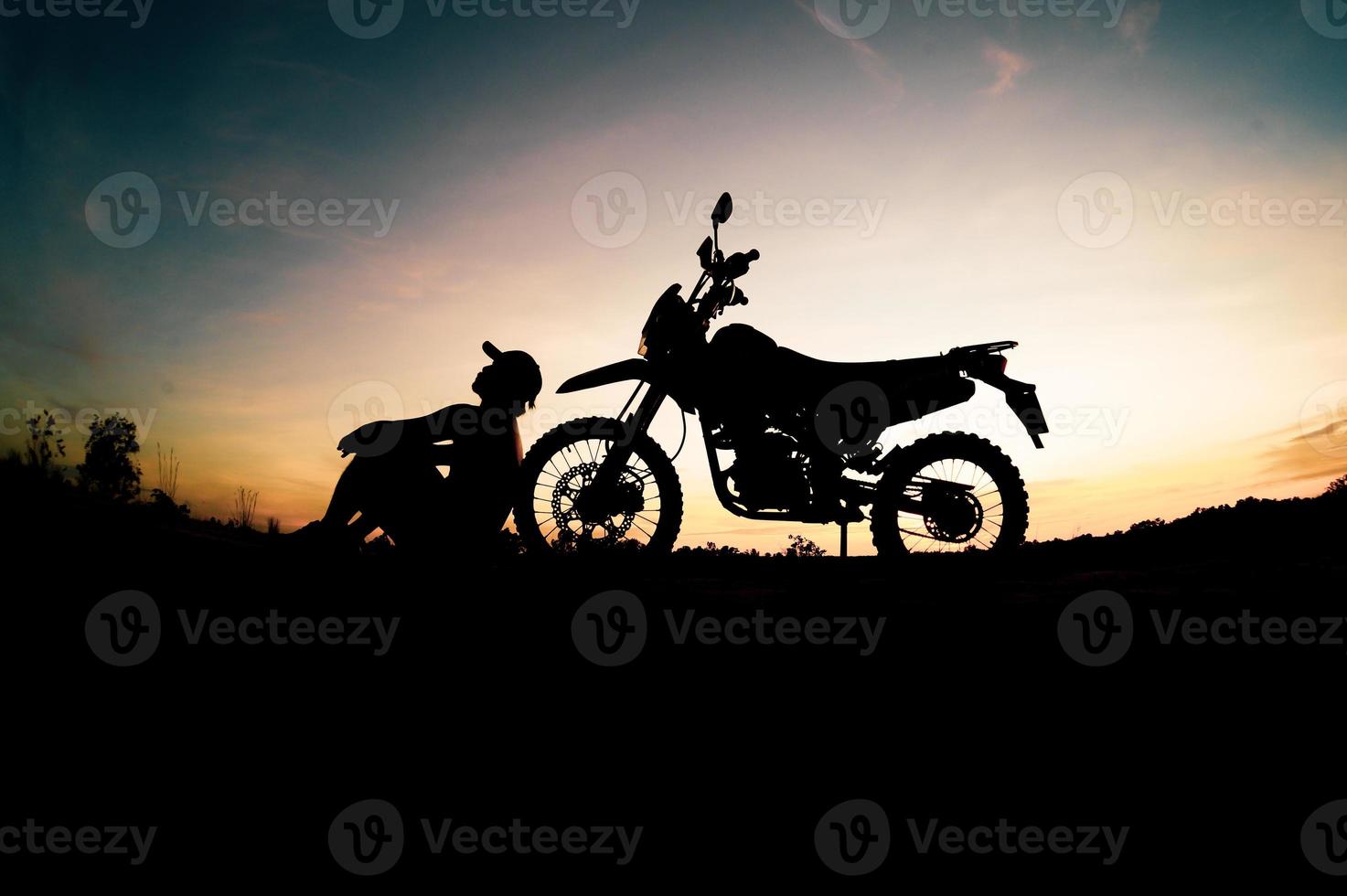 Men's silhouettes and touring motocross bikes. Park to relax in the mountains in the evening. adventure travel and leisure concept photo