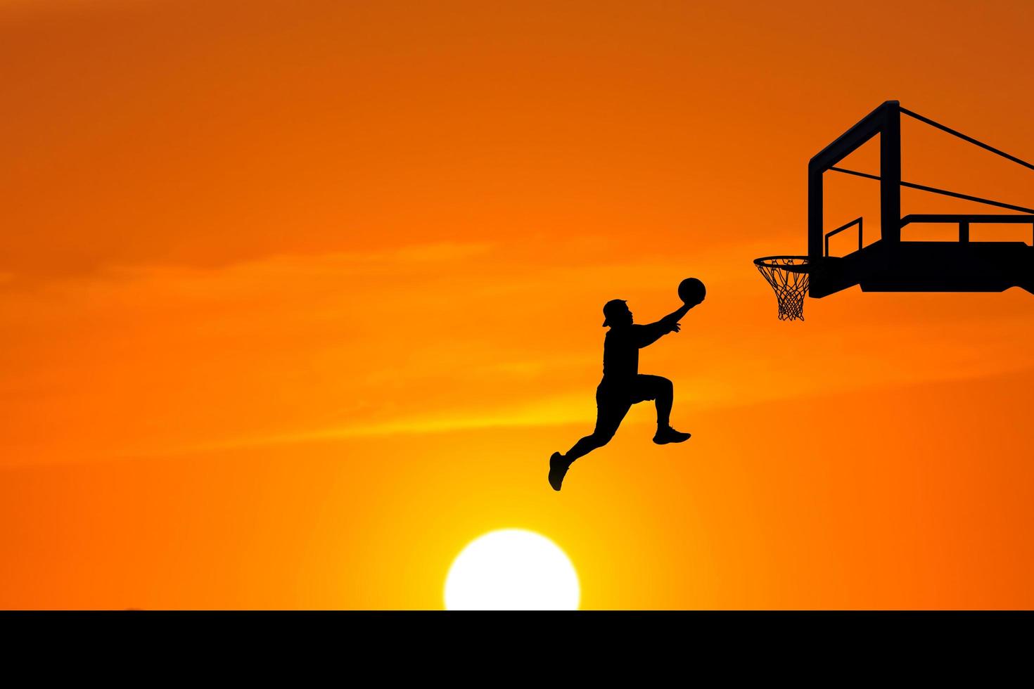 basketball player silhouette jumping photo