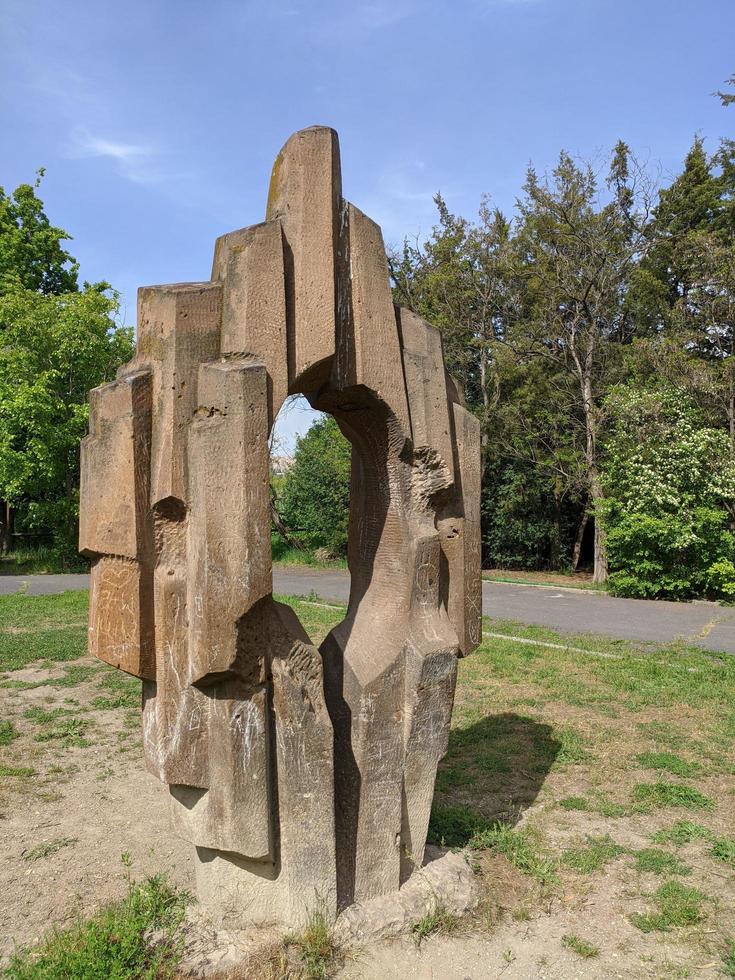 Rock geometric sculpture with hole in a nature. photo