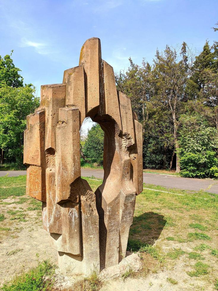 Rock geometric sculpture with hole in a nature. photo