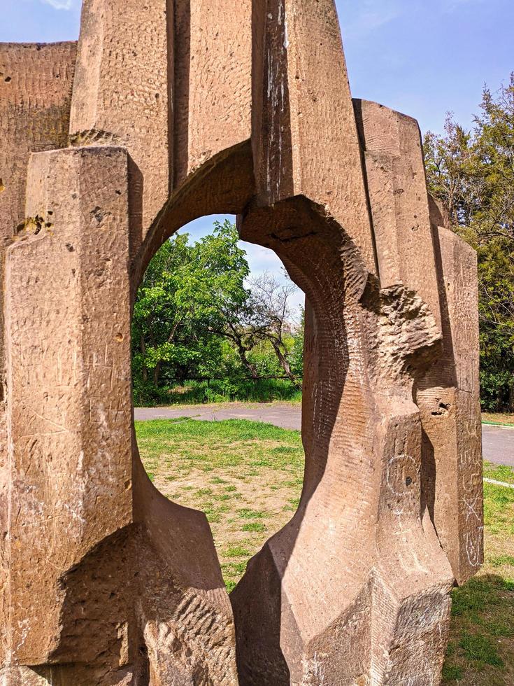 Rock geometric sculpture with hole in a nature. photo