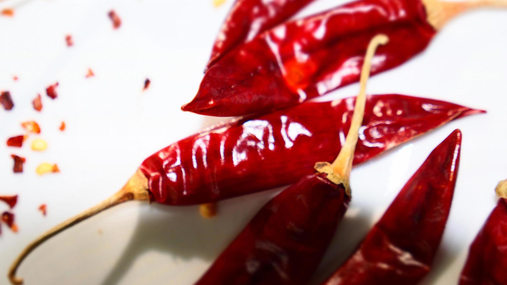 Red Chili Peppers, Chili Pepper Flakes shown against a white background photo