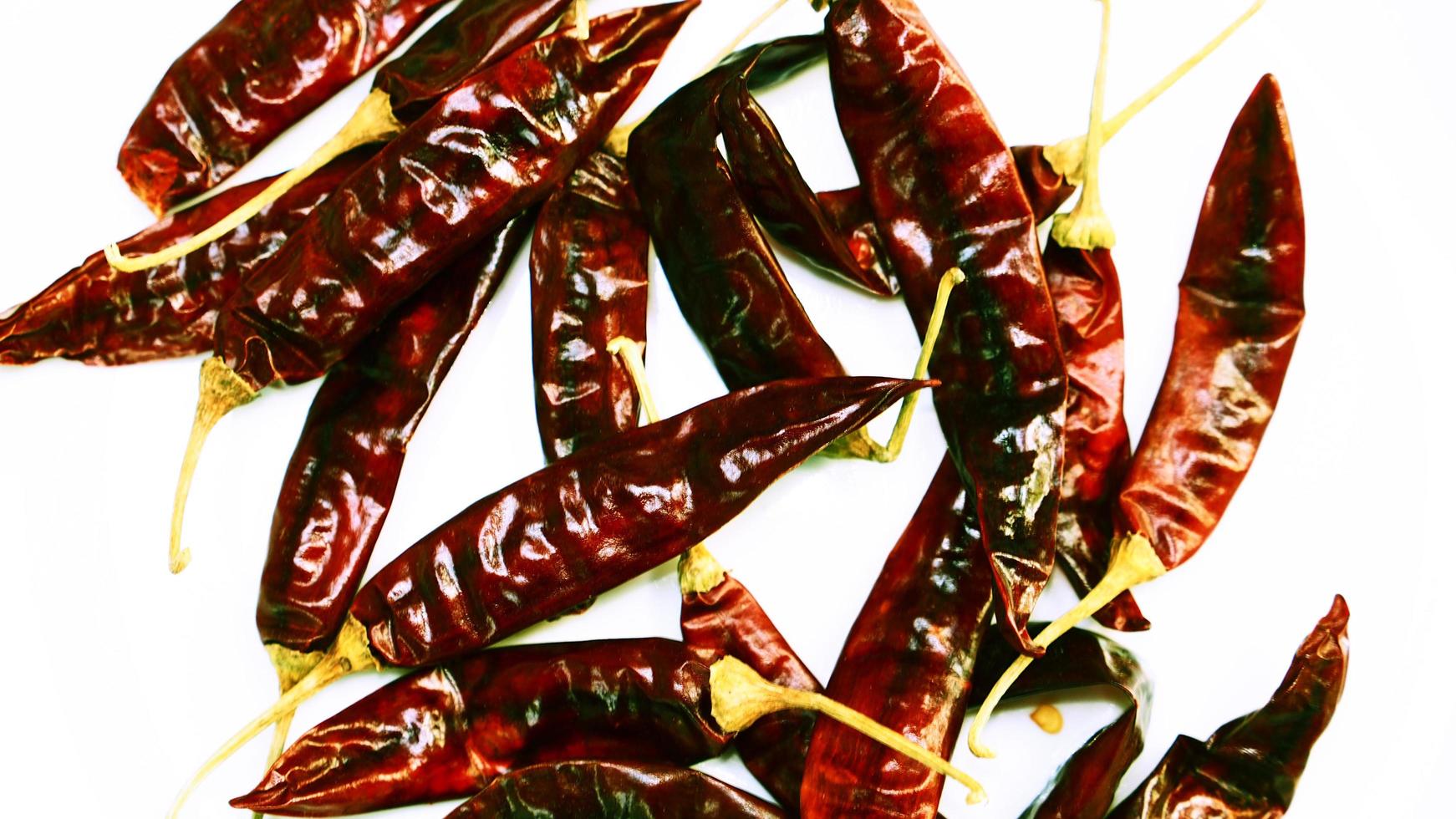 Red Chili Peppers, Chili Pepper Flakes shown against a white background photo