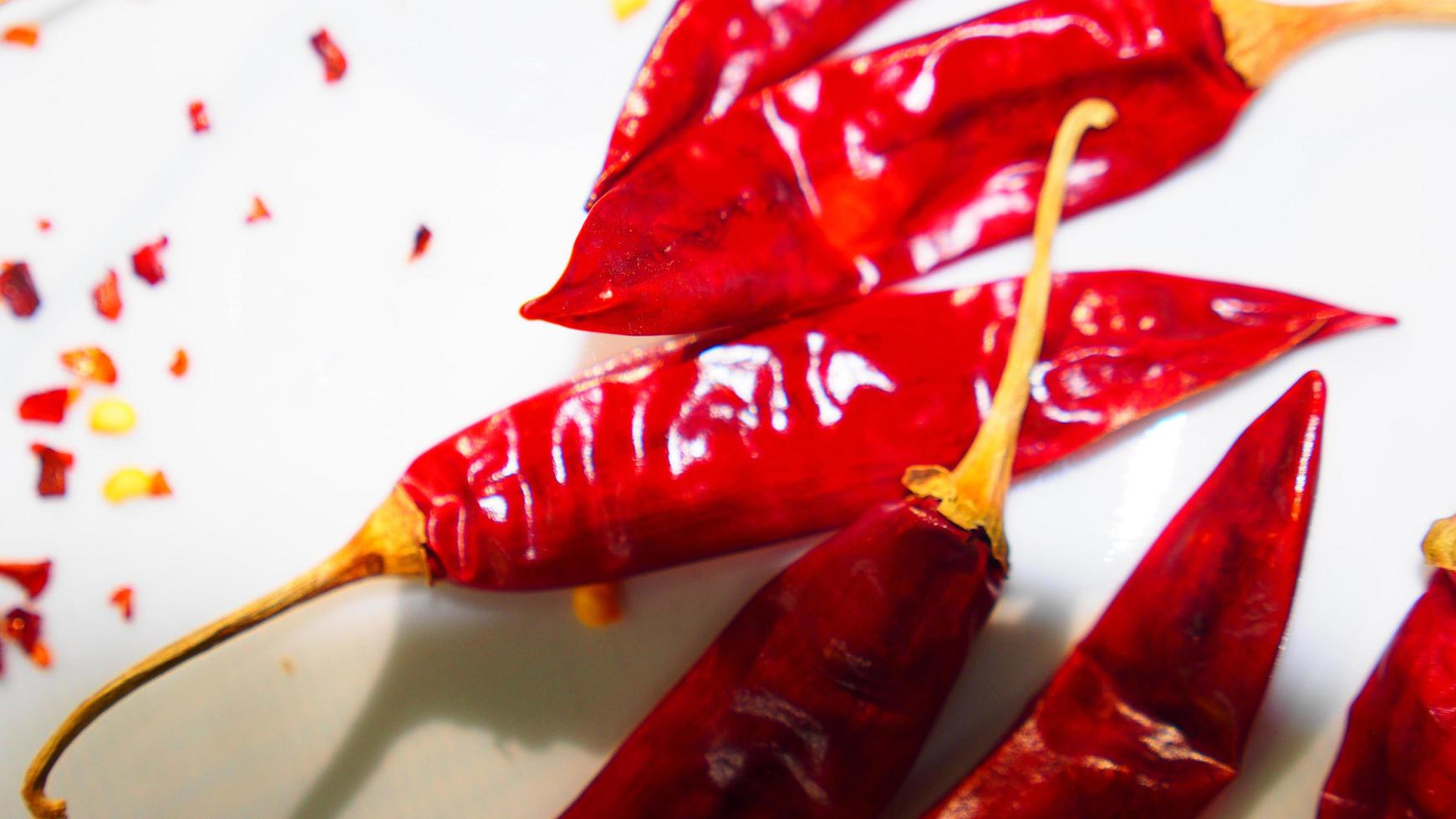 Red Chili Peppers, Chili Pepper Flakes shown against a white background photo