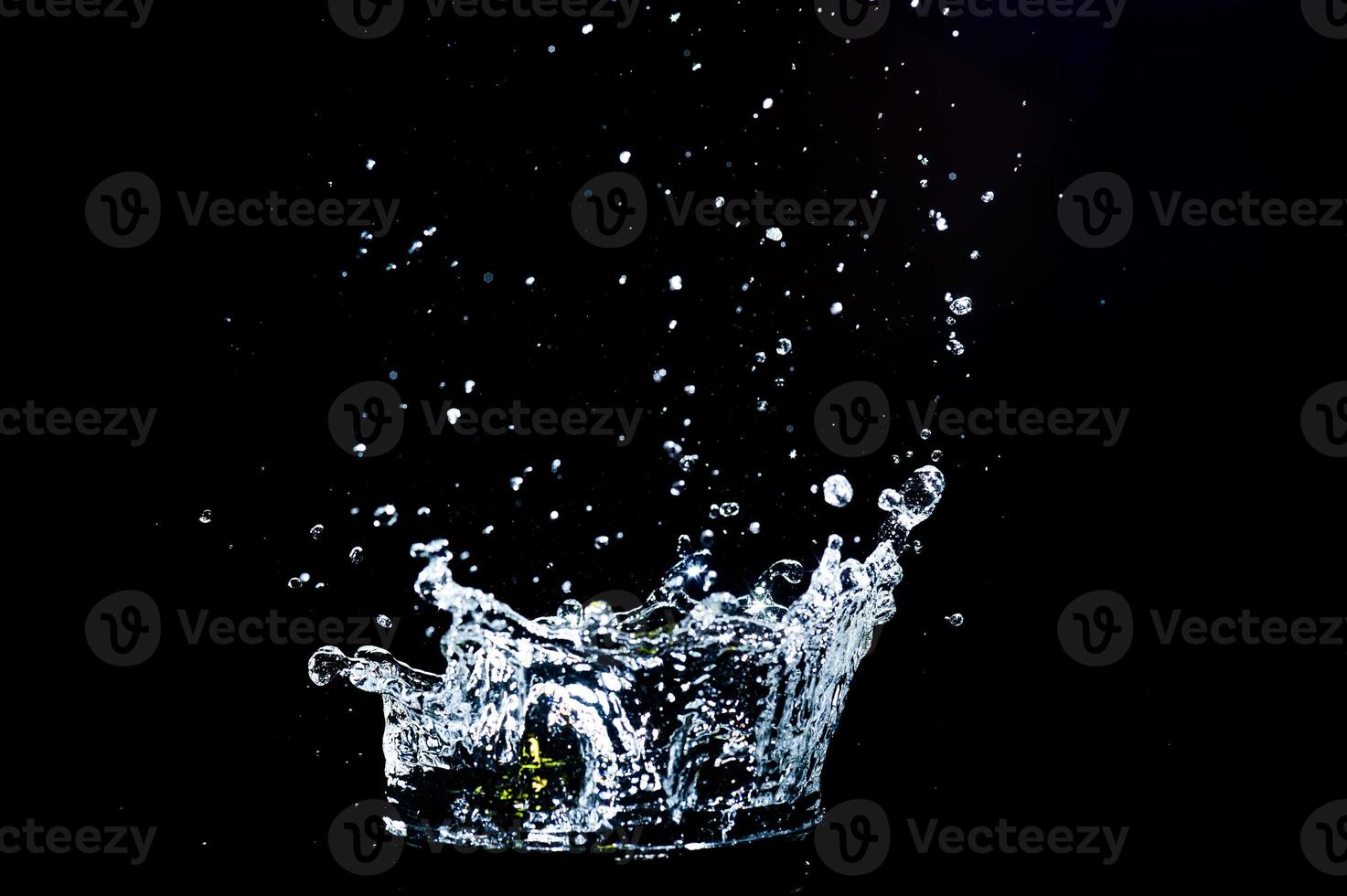 Scattered water splashes on a black background. water splash isolated on the black background photo