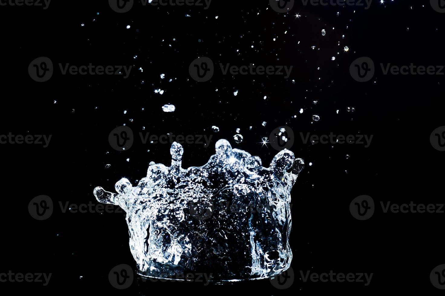 Scattered water splashes on a black background. water splash isolated on the black background photo
