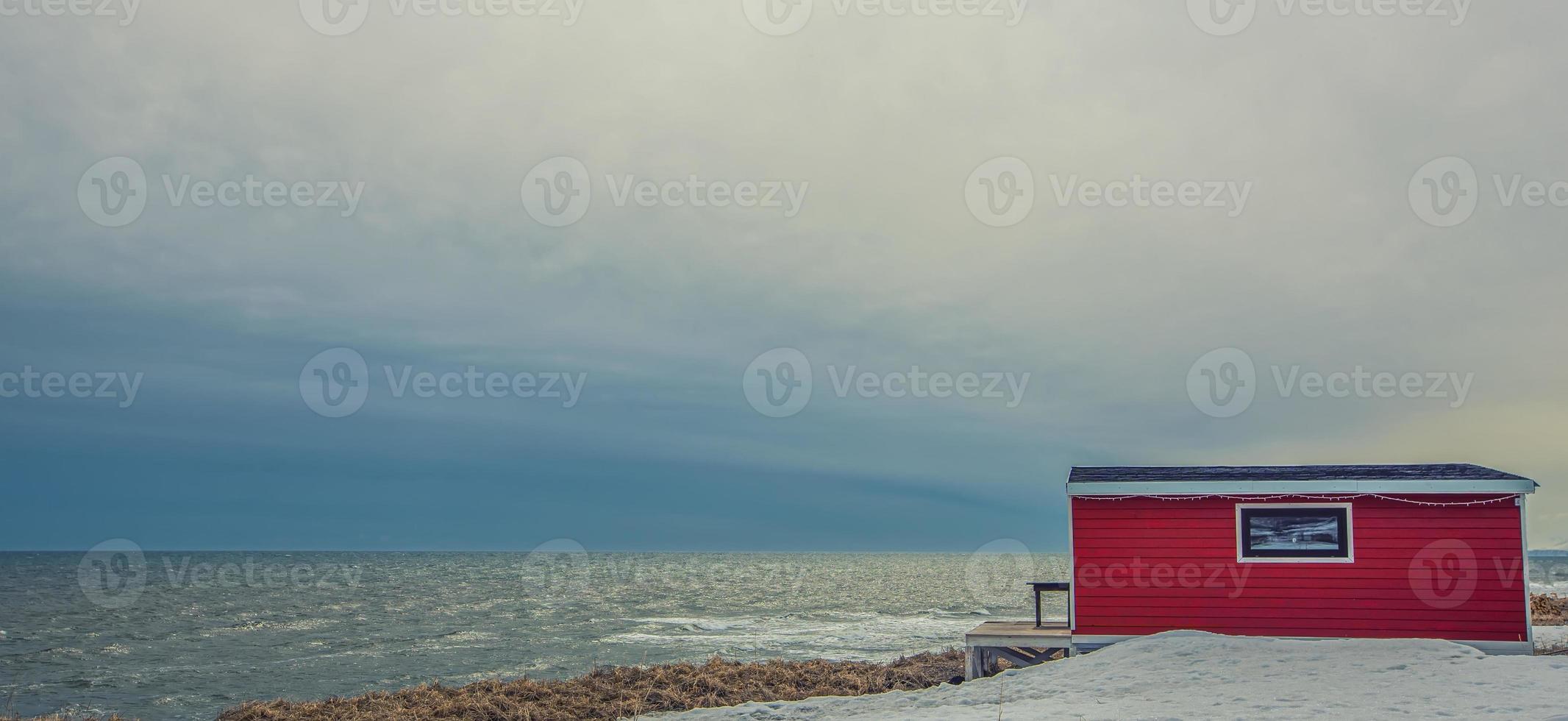 lonely red house on the sea in kamchatka Peninsula photo