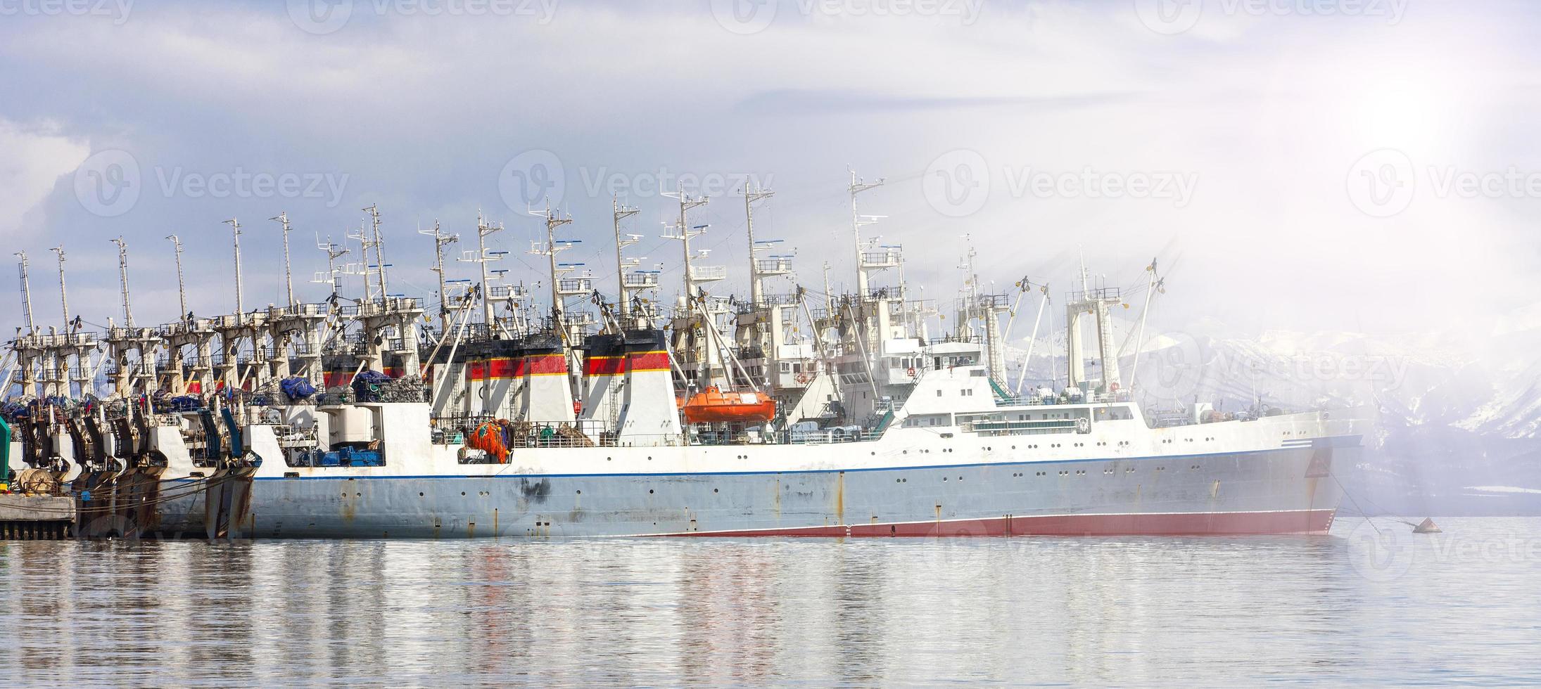 Fishing seiners near the pier in Avacha Bay in Kamchatka in soft diffused light photo