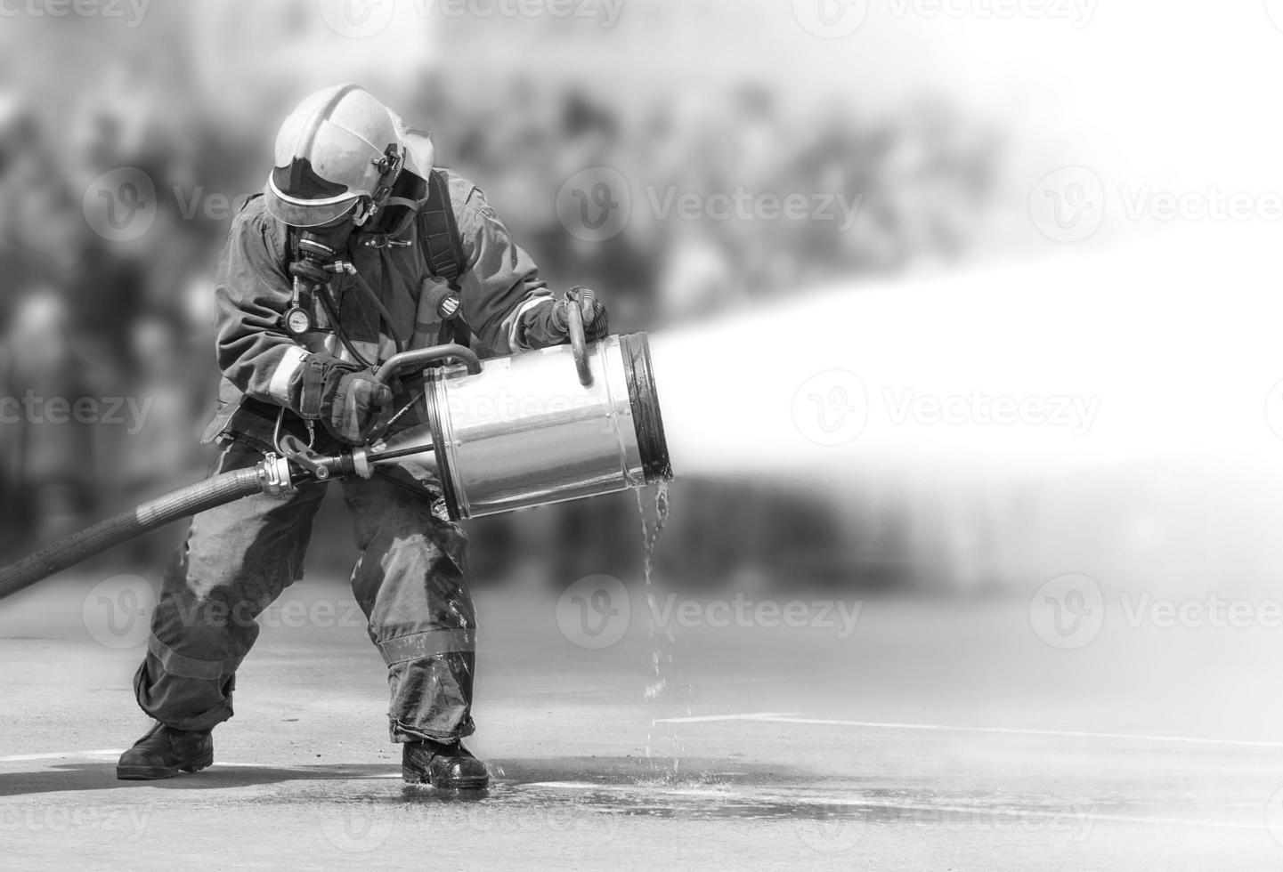Firefighters while extinguishing the fire with a special fire extinguishing equipment. photo
