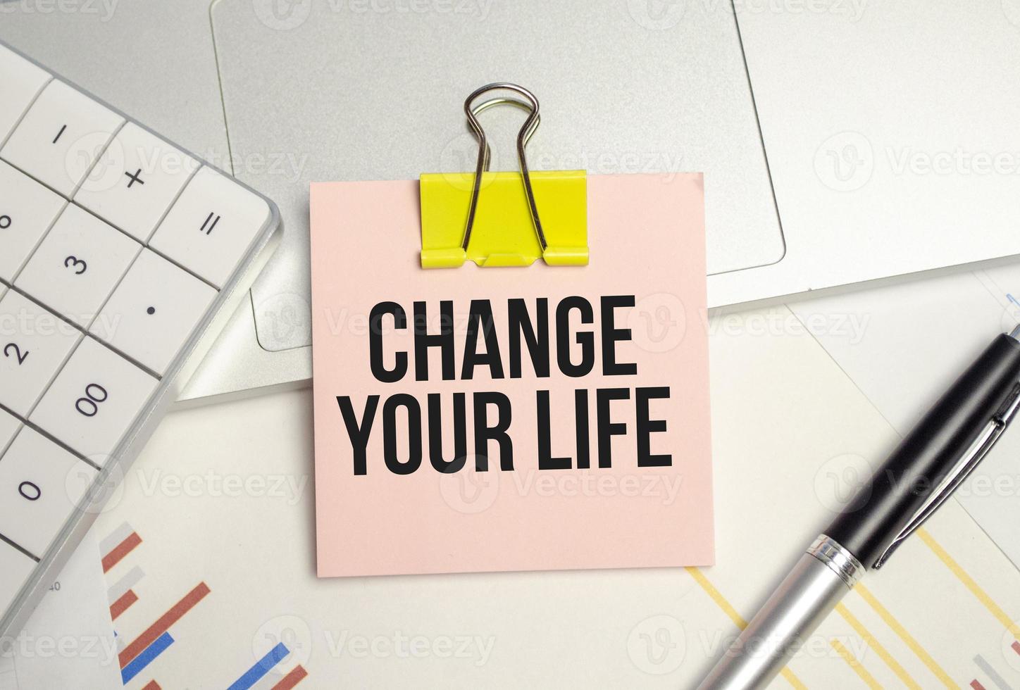 change your life on sticker with pen, calculator and charts photo