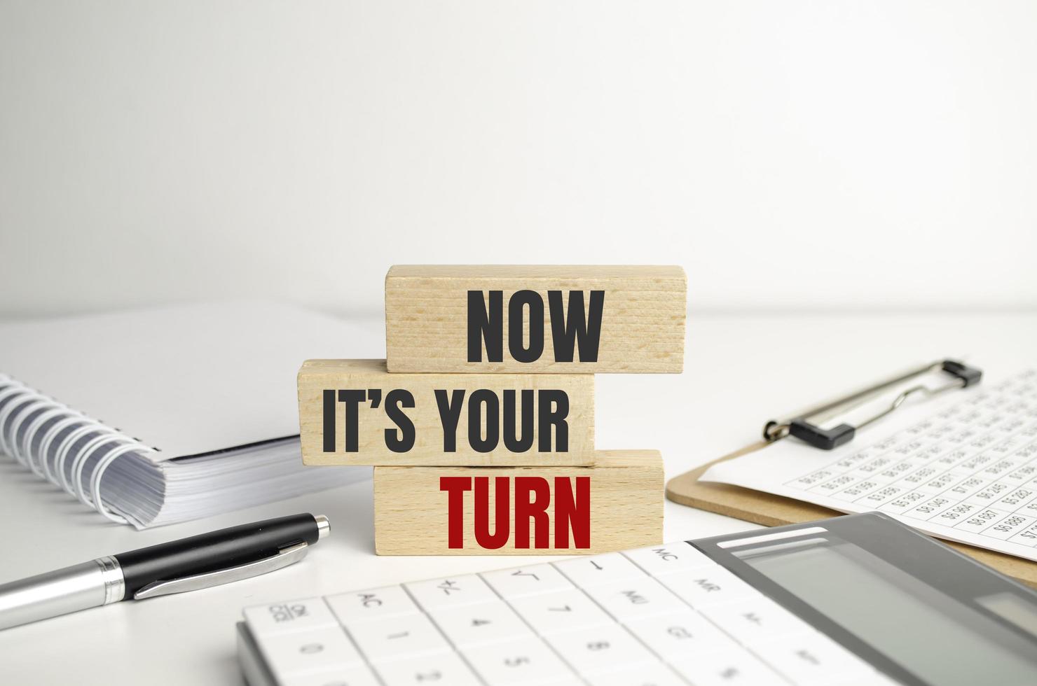 NOW IT'S YOUR TURN text on wooden blocks with office tools photo