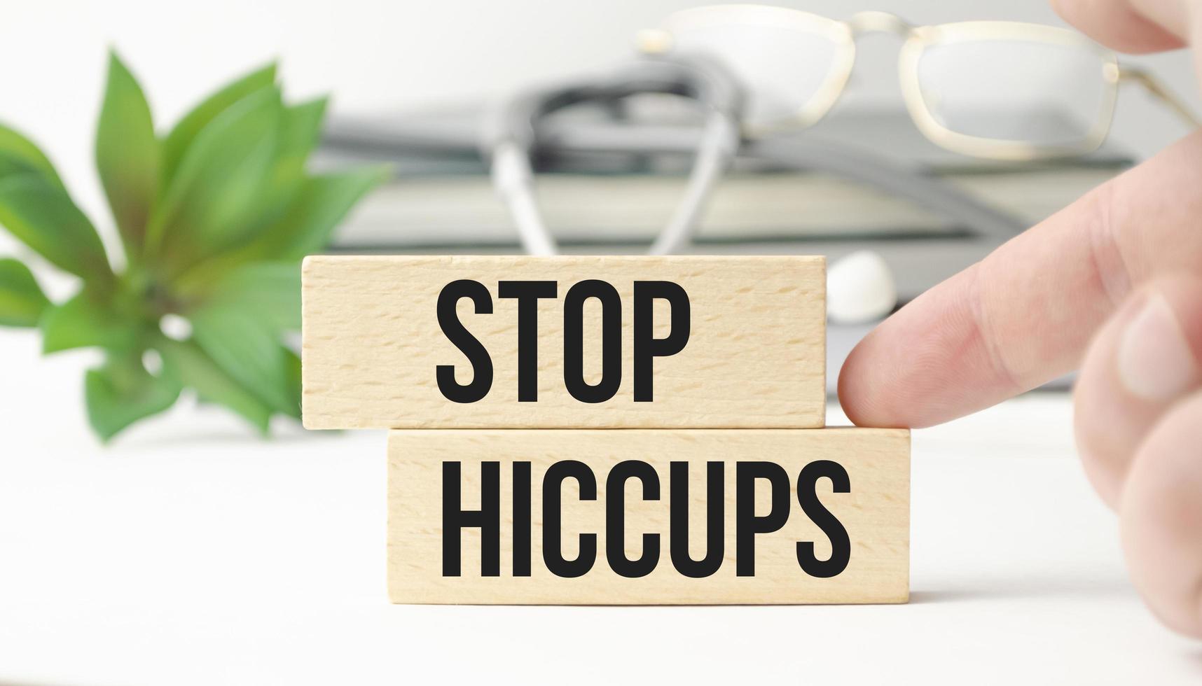 The words STOP HICCUPS is made of wooden cubes photo