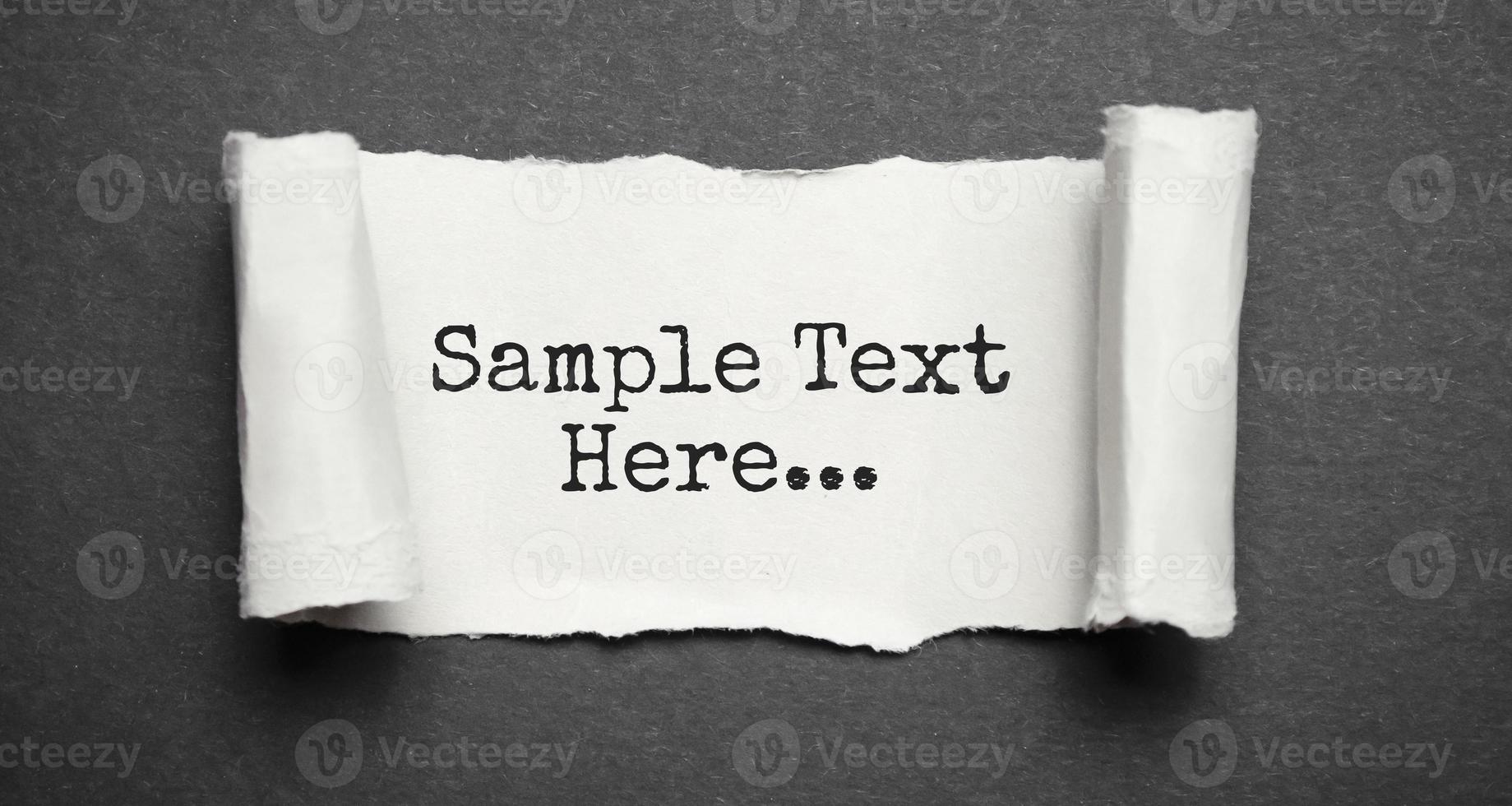 Sample text here words on the grey torn paper photo