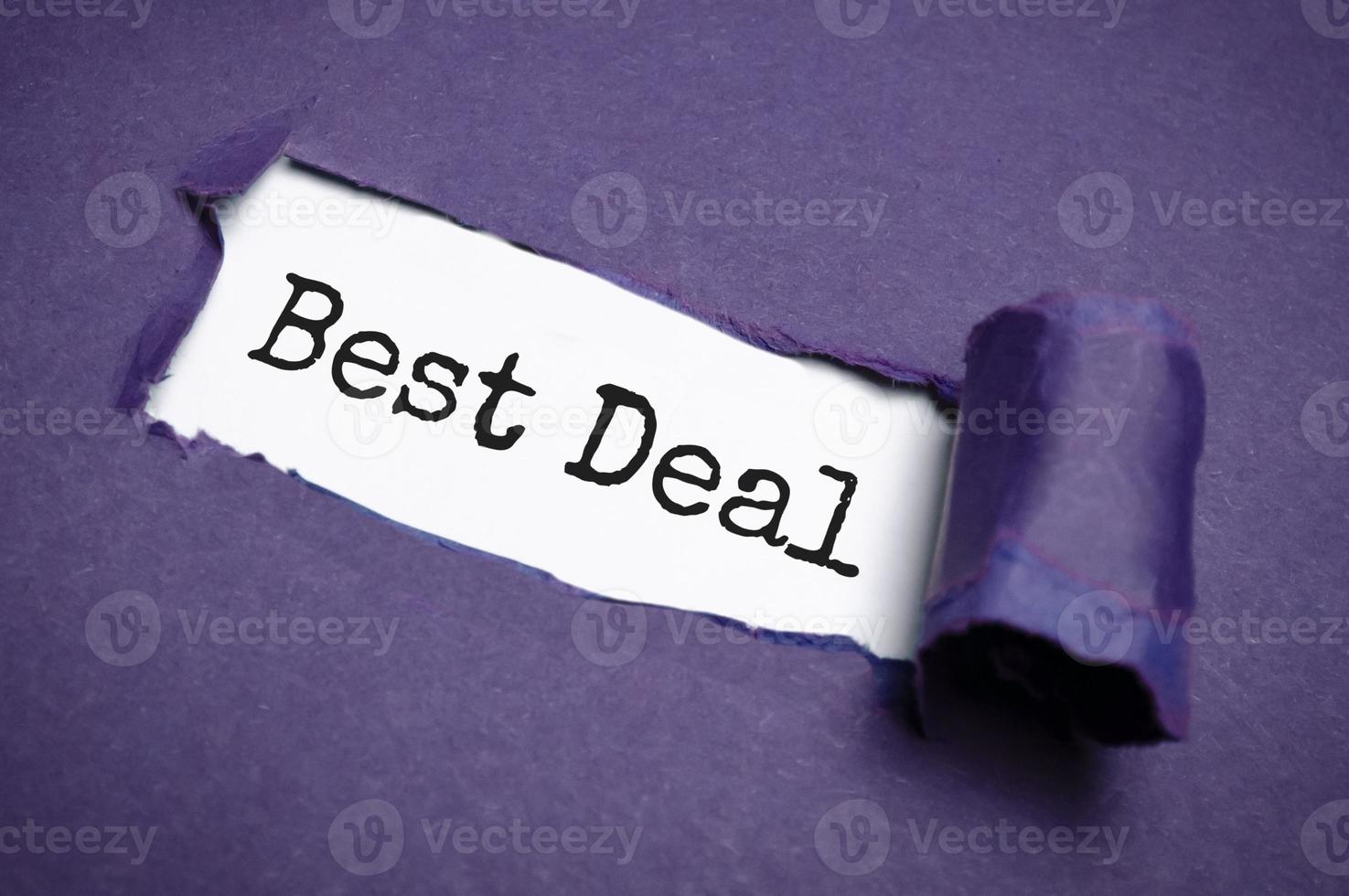 best deal word on paper over torn paper background. photo