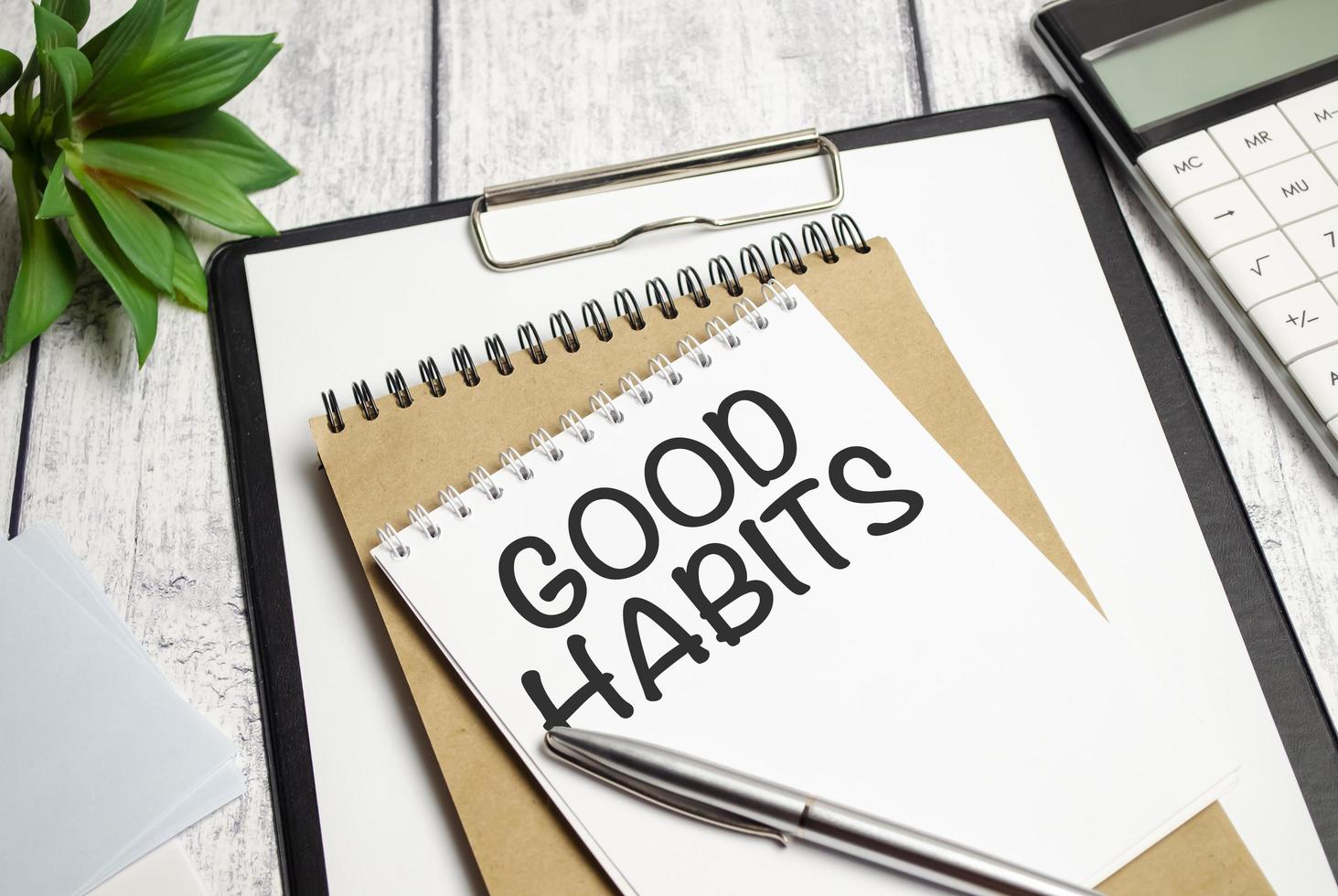 Good Habits text on notebook with pen on wooden background photo