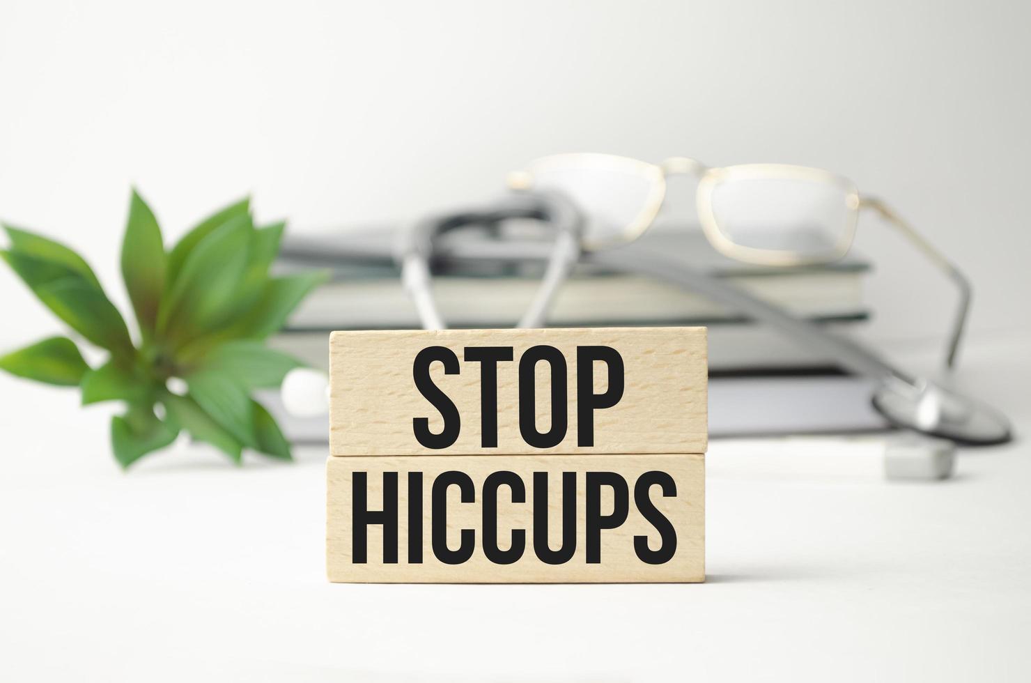 The words STOP HICCUPS is made of wooden cubes photo