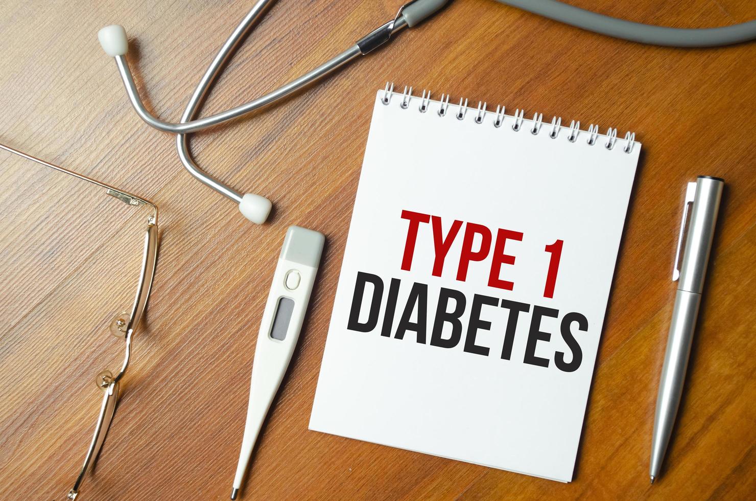 types 1 Diabetes. text on white paper in notebook near stethoscope photo