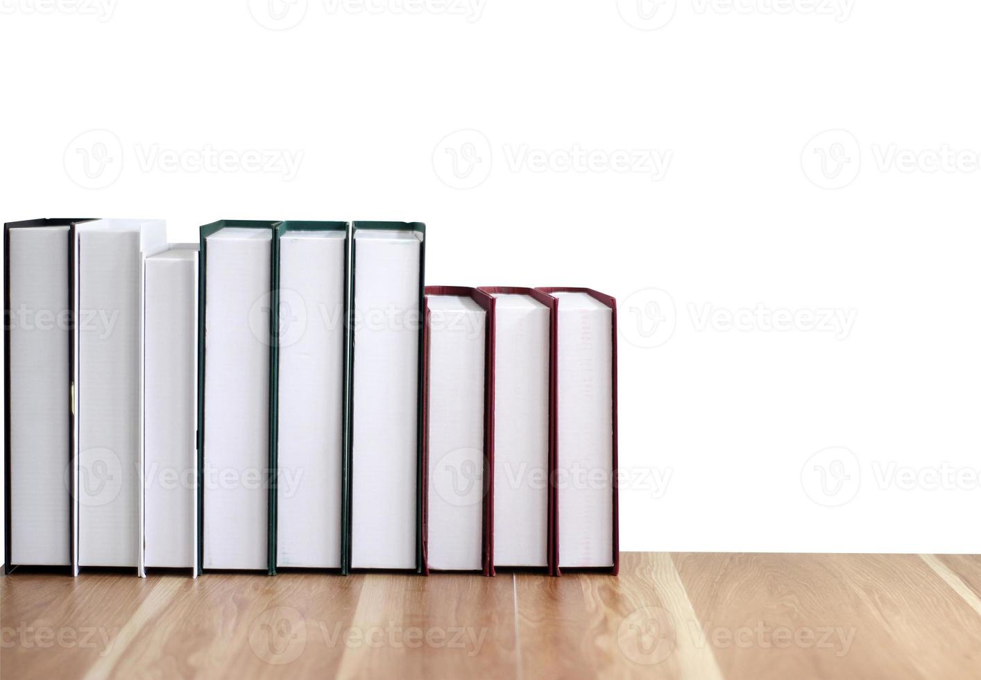 new books on a wooden table isolated on white background photo