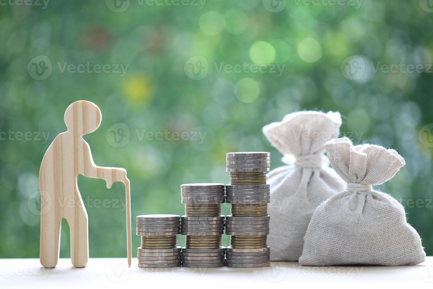 Mutual fund,Senior man and stack of coins money on natural green background, Save money for prepare in future and pension retirement concept photo