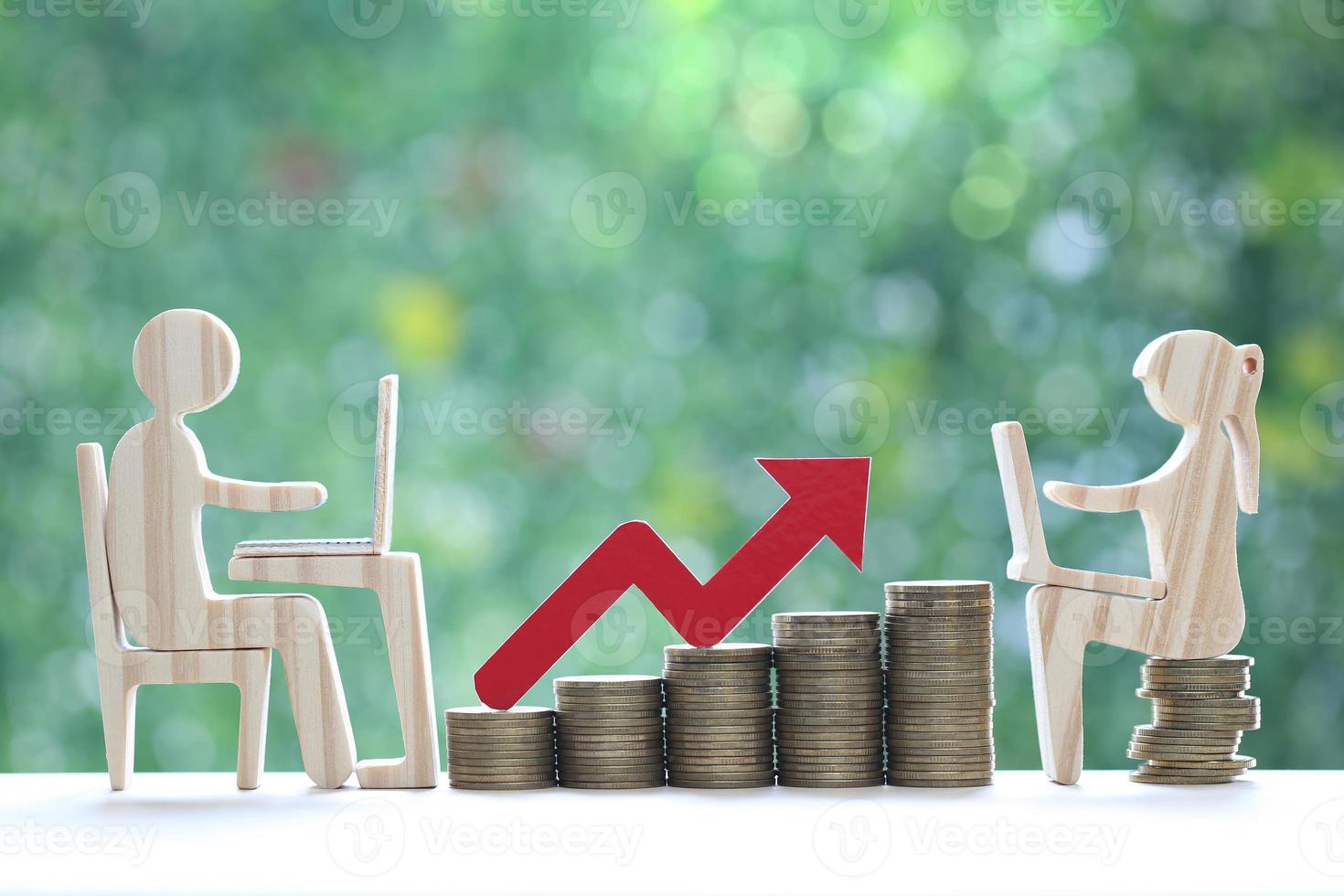 Investment and business concept,Man and woman using laptop computer with stack of coin money and red arrow graph on natural green background,Investors strategy photo