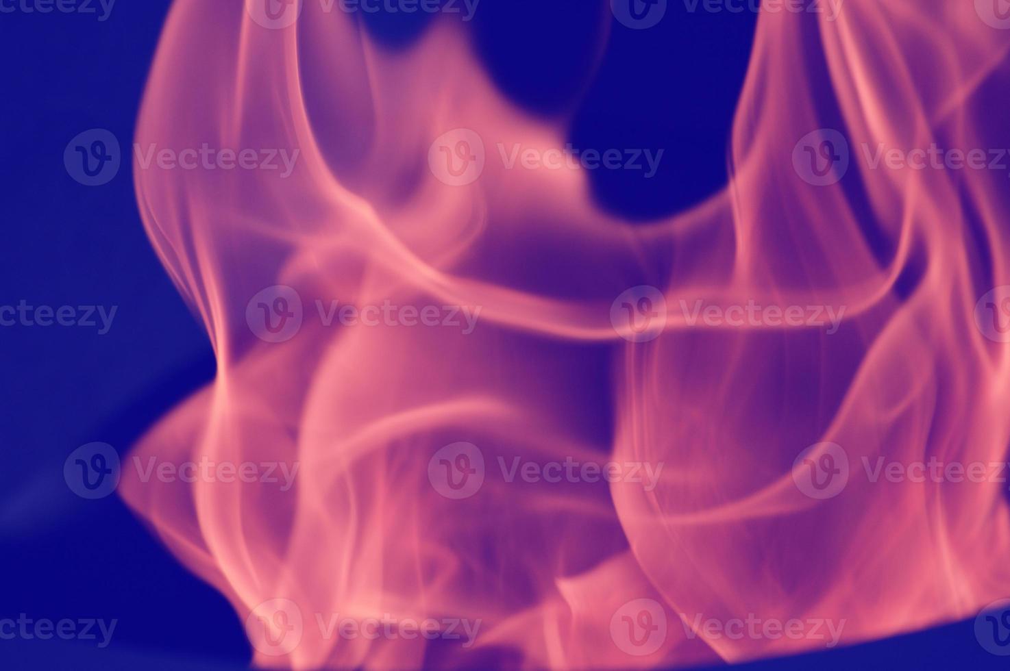 Pink-purple swirling bright smoke, dynamic paint in water, flames. Abstract creative background. photo