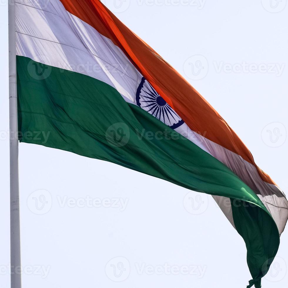 India flag flying high at Connaught Place with pride in blue sky, India flag fluttering, Indian Flag on Independence Day and Republic Day of India, tilt up shot, waving Indian flag, Flying India flags photo