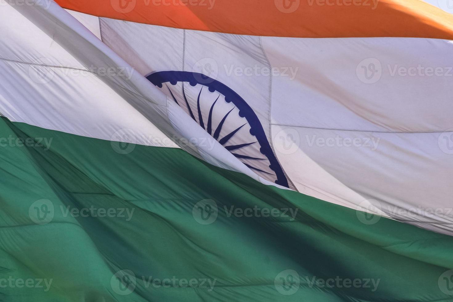 India flag flying high at Connaught Place with pride in blue sky, India flag fluttering, Indian Flag on Independence Day and Republic Day of India, tilt up shot, waving Indian flag, Flying India flags photo