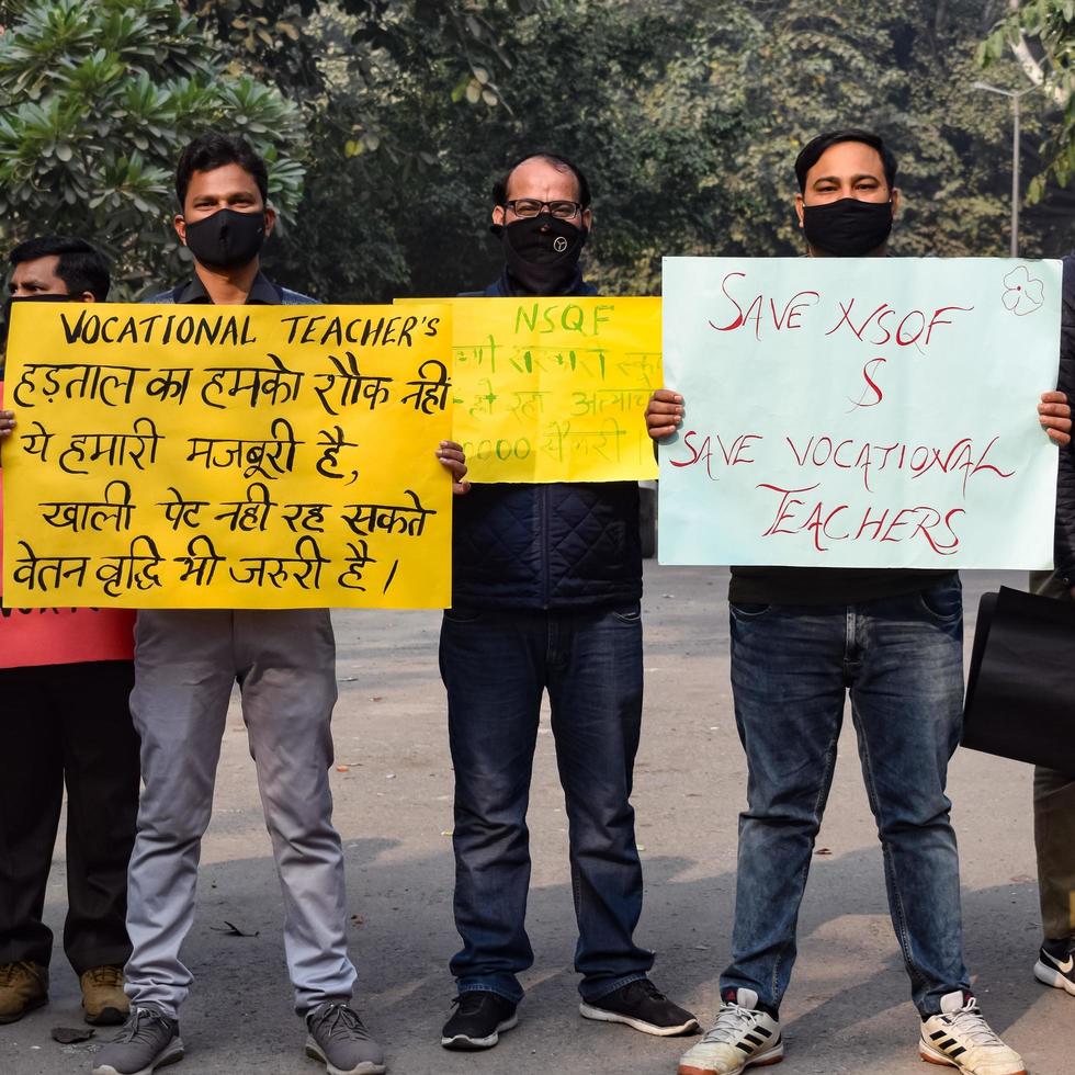 New Delhi, India December 25 2021 - Delhi Contractual Guest Teachers with posters, flags and graffiti protesting against Delhi AAP Government for making policy, Delhi Guest Teachers protesting photo