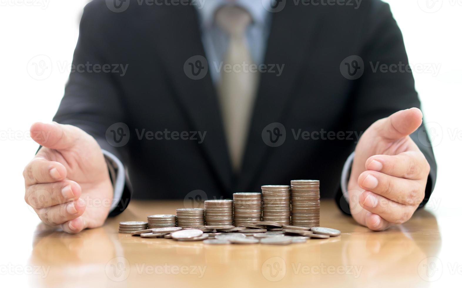 Businessman Protect Stack Of Coins photo