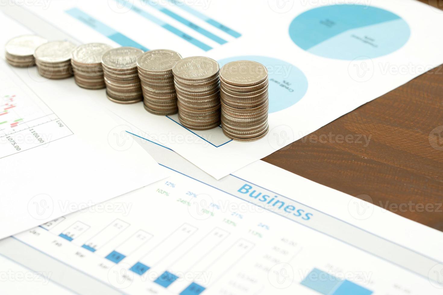 Business chart with paper clips, coins photo