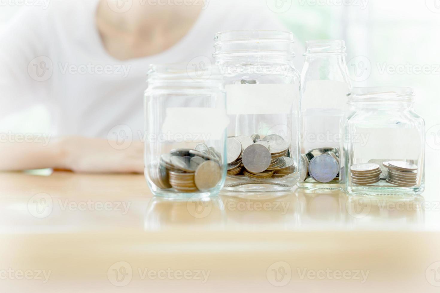 The woman hid behind a jar full of coins photo
