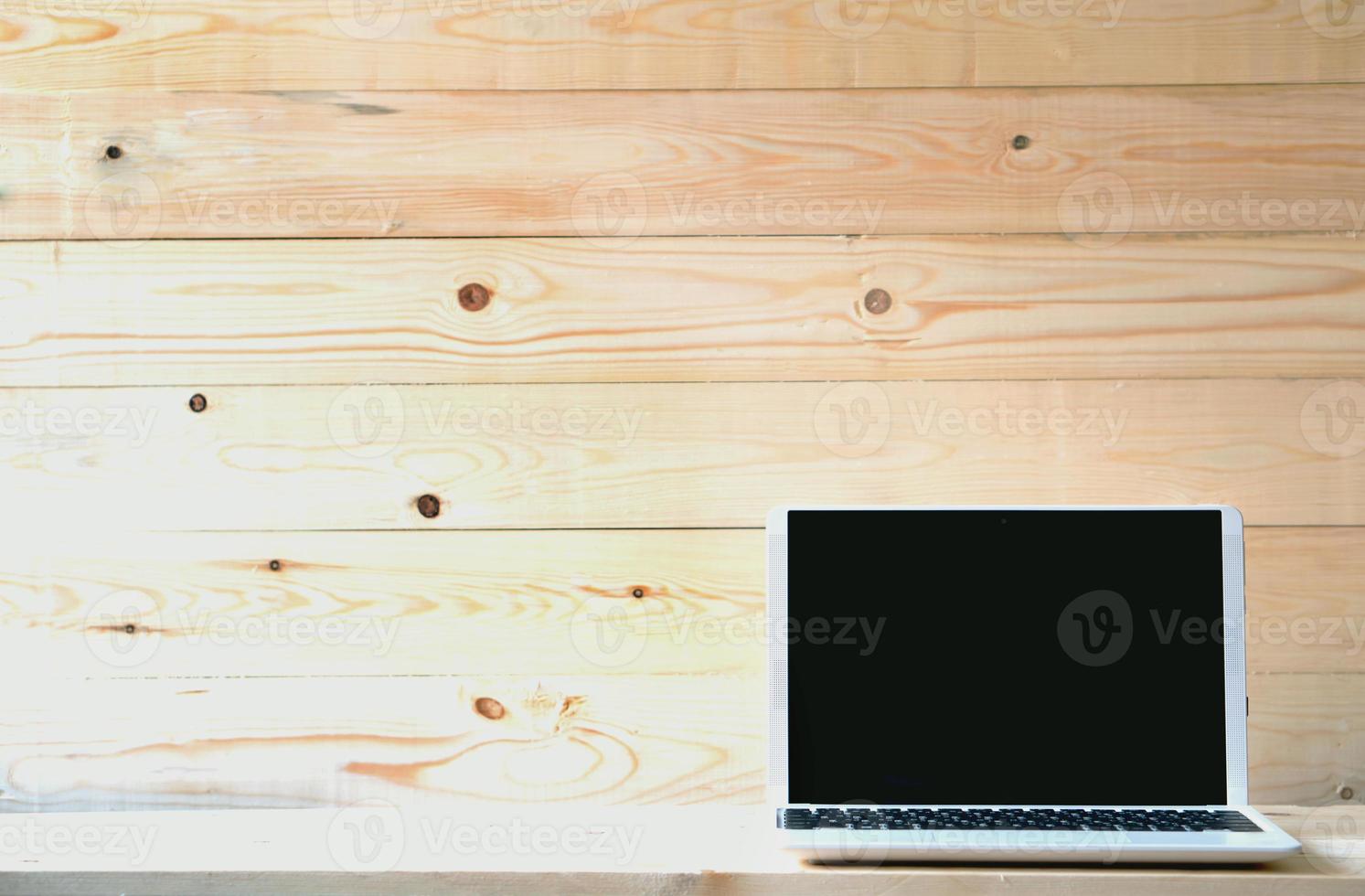 Computer,laptop with blank screen on wood table photo