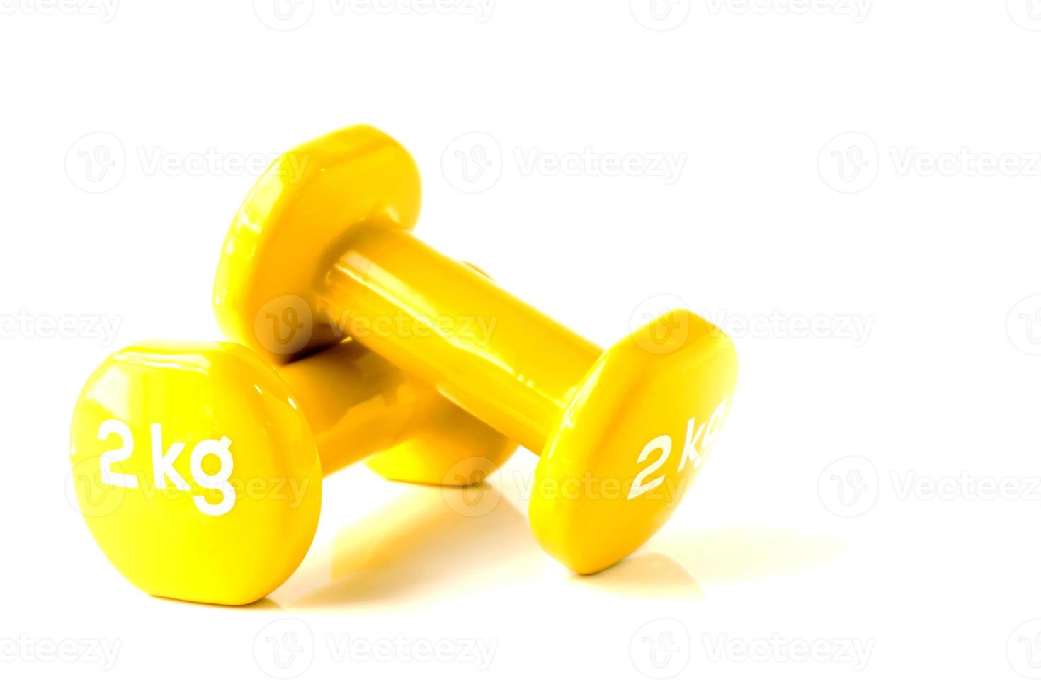 Light yellow dumbbell weight in white background photo