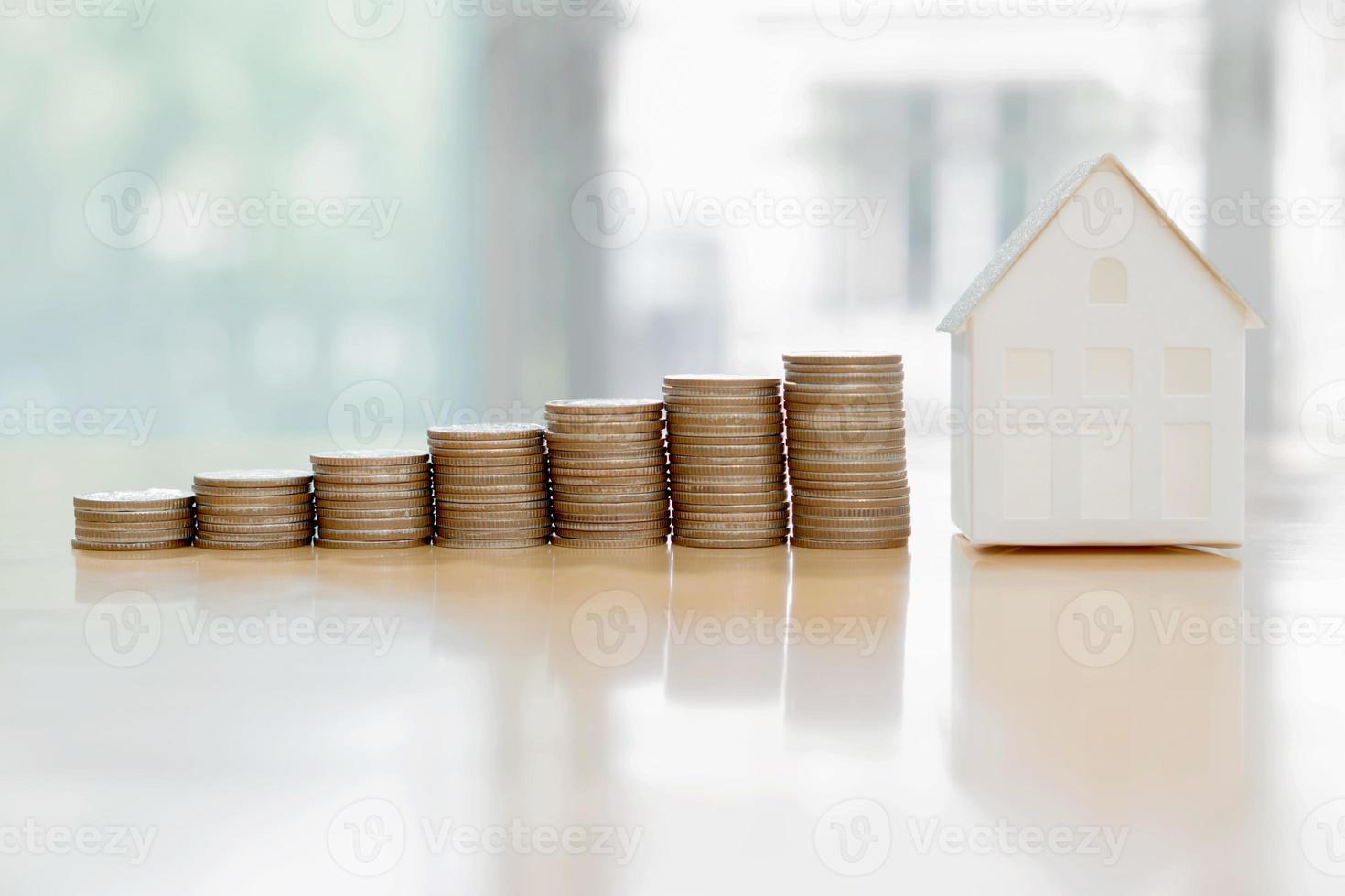 House model and coin money,mortgage and real estate investment. photo