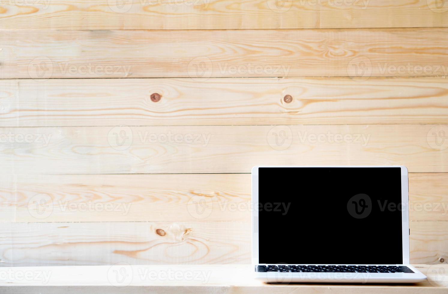 Computer,laptop with blank screen on wood table photo