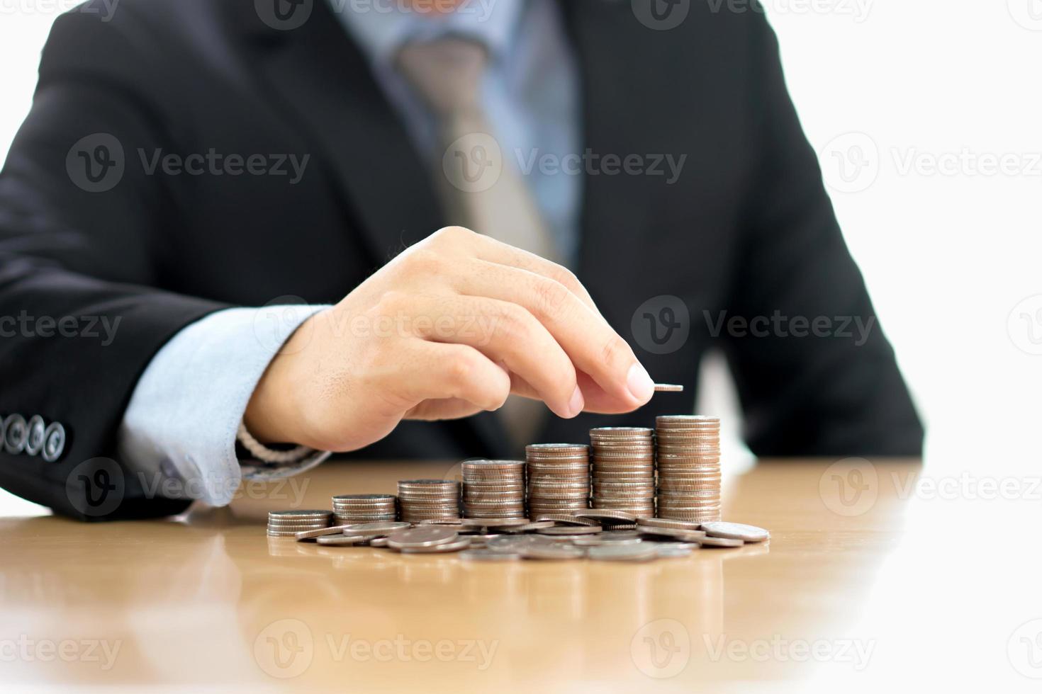 Hand putting stack of coins photo
