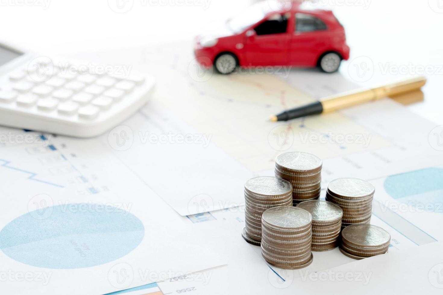 Calculator pen and  coins on financial report. photo